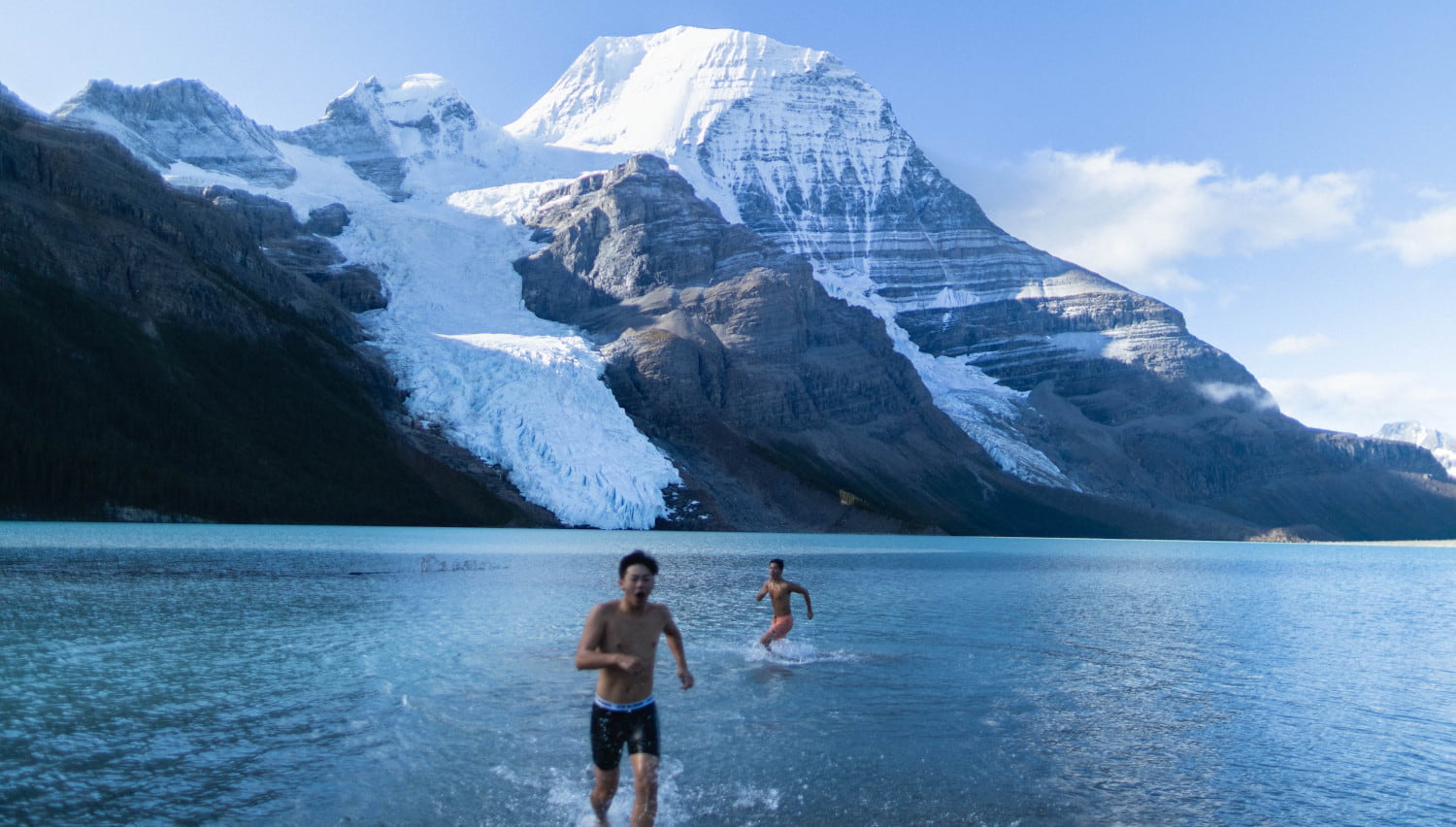 a couple of people that are standing in the water