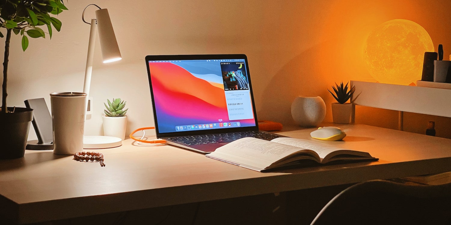 macbook air with a book