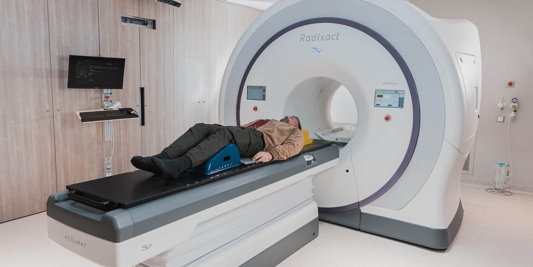 A person is prepared to be scanned using a computed tomography (CT) scan machine.
